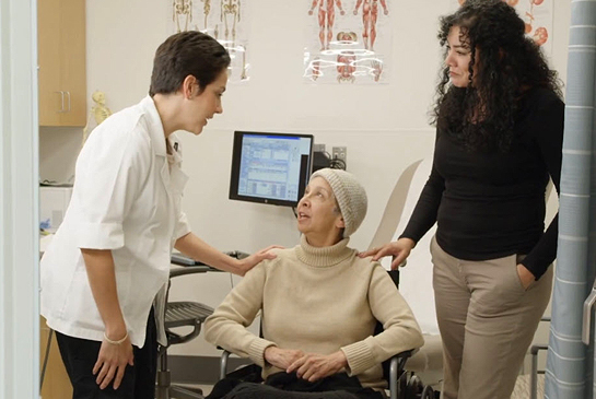 Health care workers assisting an older patient (c) UC Regents. All rights reserved.
